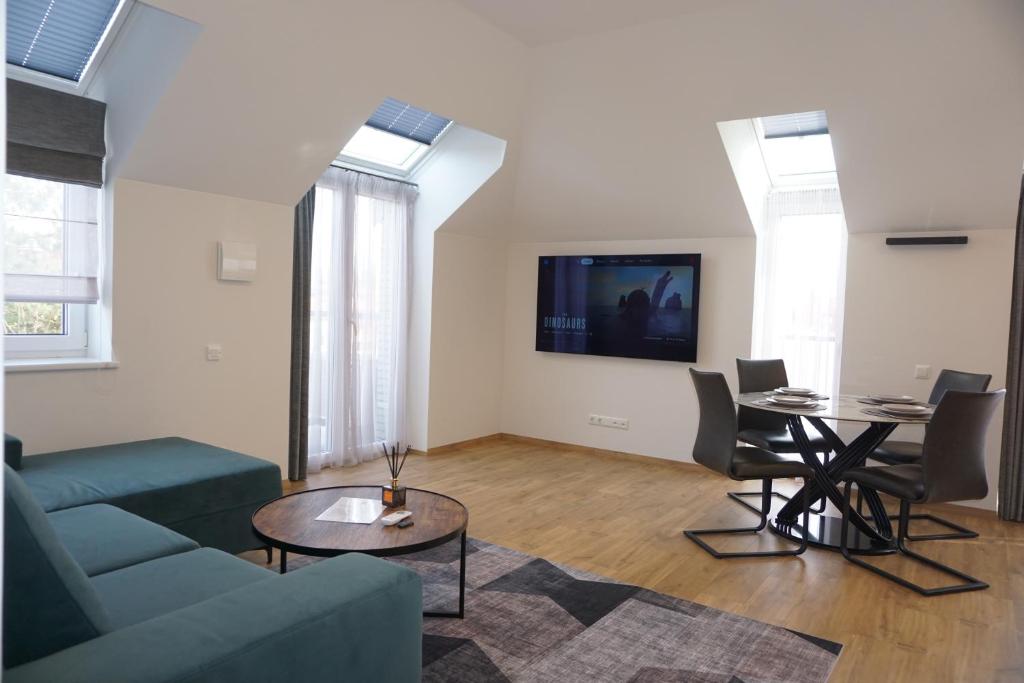 a living room with a couch and a table at Modern New-Build Apt, managed by RentiFor in Klaipėda