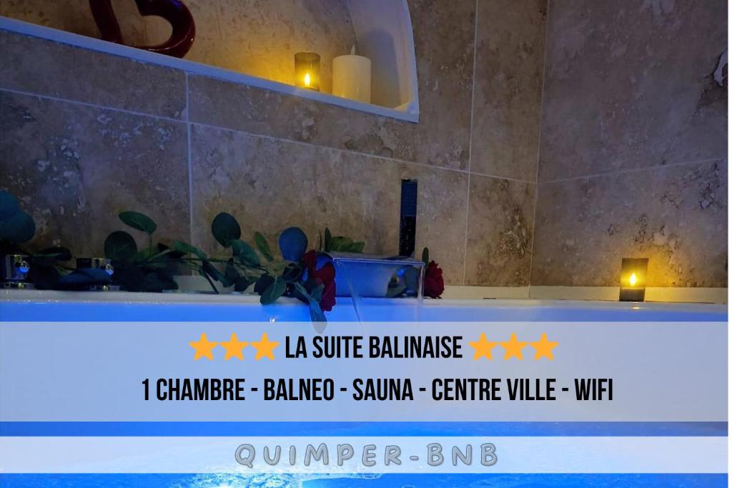 a table with a sign on it in a bathroom at La Suite Balinaise in Quimper