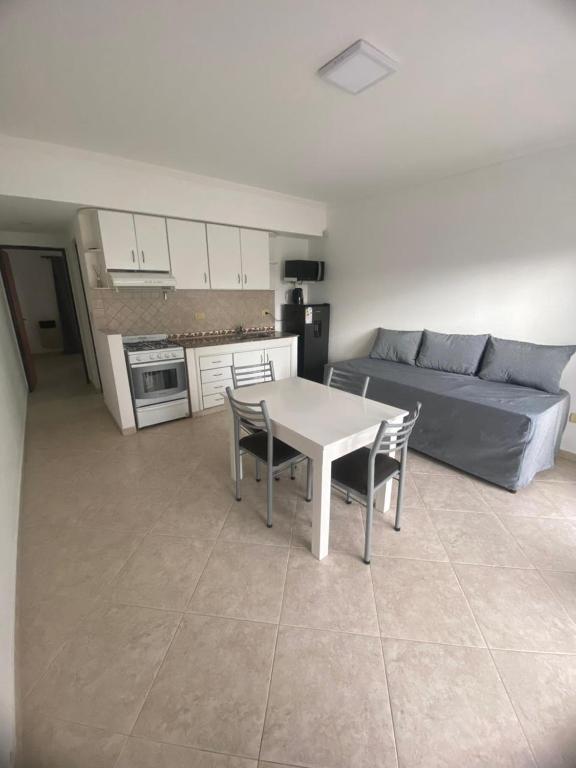 a living room with a table and chairs and a couch at Patagonico in Puerto Madryn
