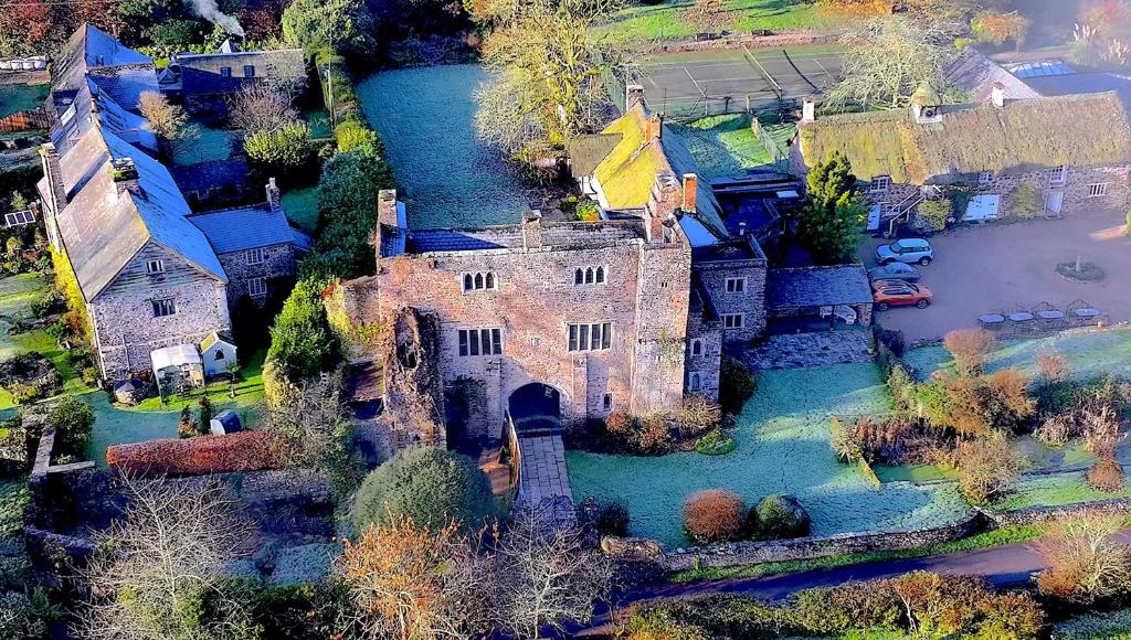 an aerial view of an old castle and a river at Bickleigh Castle - A Majestic Devon Estate for Exclusive Gatherings in Winkleigh