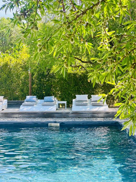 a group of beds sitting next to a swimming pool at Domaine La Parpaille in Cucuron
