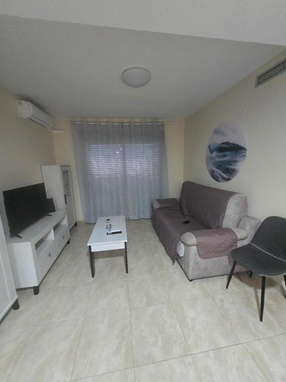 a living room with a couch and a table at Las Jarcias 3A in Moncófar