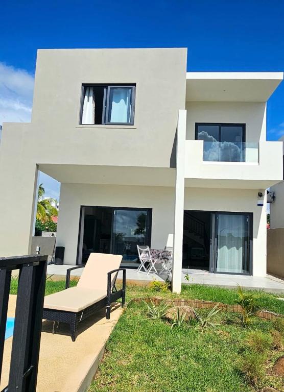 a white house with a view of the ocean at Entire villa with private pool and seaview Albion Mauritius in Albion