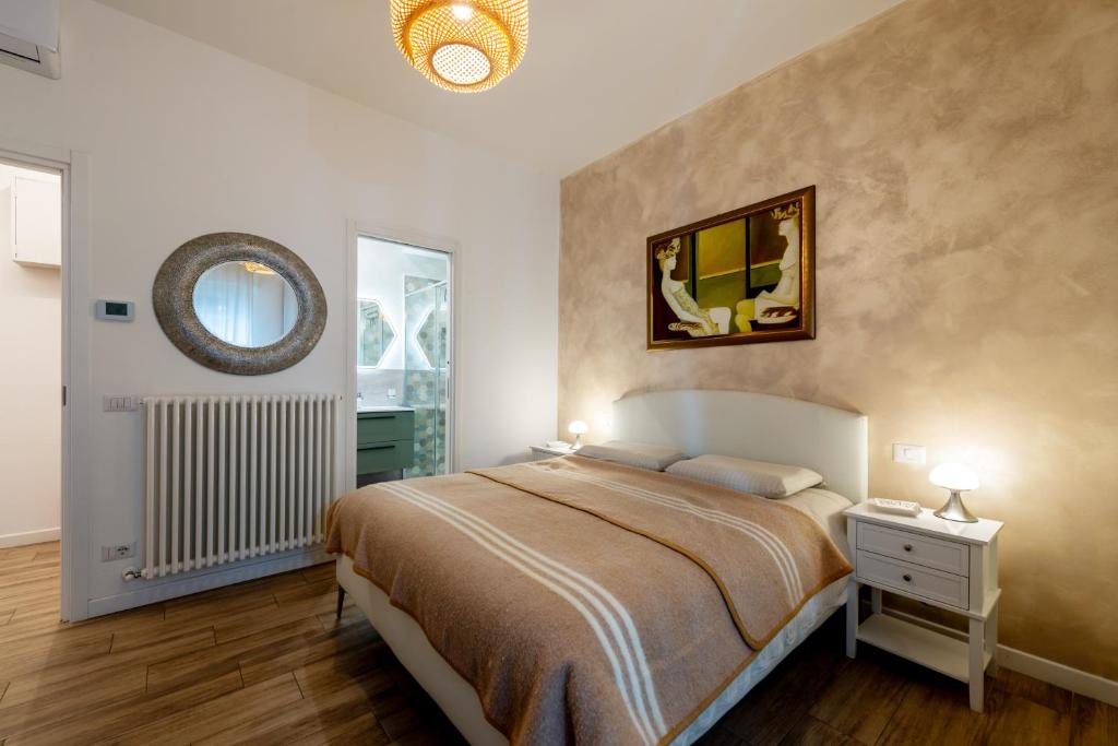a bedroom with a bed and a mirror on the wall at MARCANTONIO ROOM Ampia camera con bagno privato e self check in in Perugia