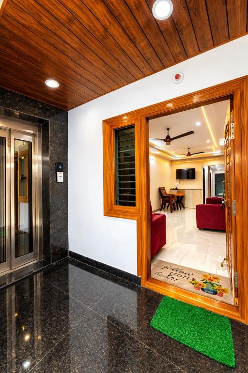 a living room with a large glass door and a living room at Vizag Urban Nest in Visakhapatnam