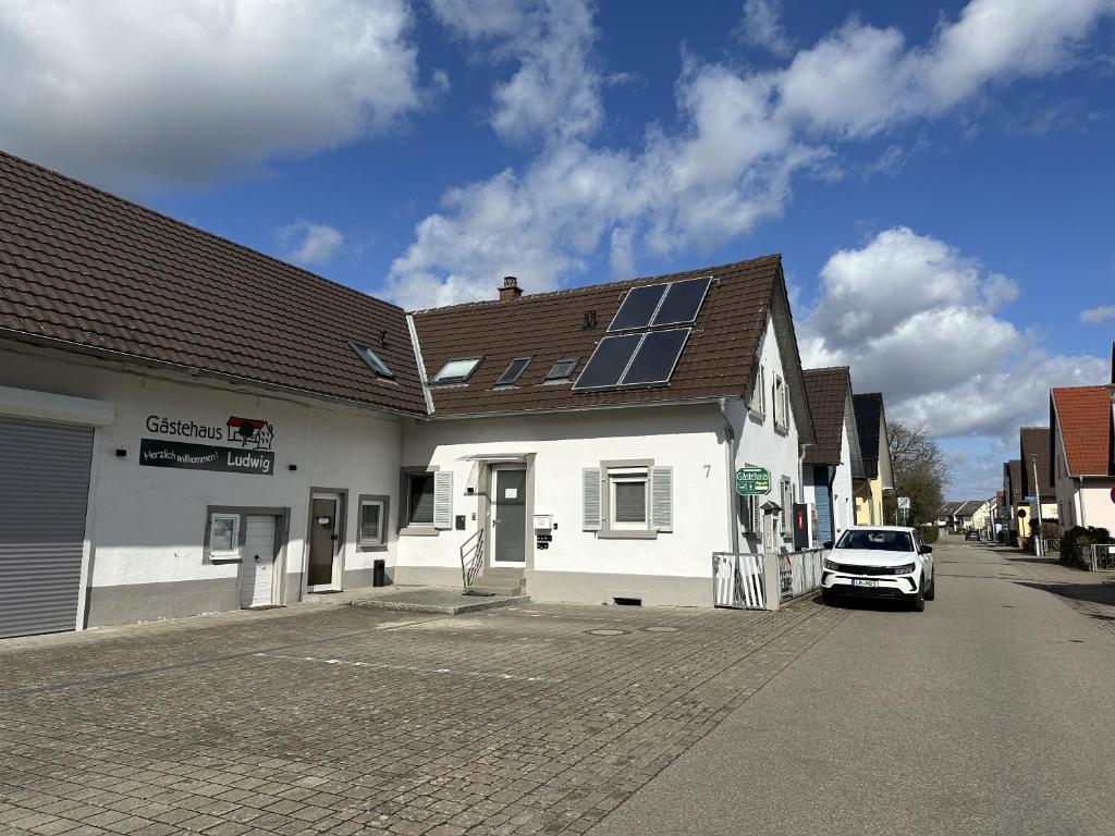 a building with a car parked in front of it at Gästehaus Ludwig in Rust