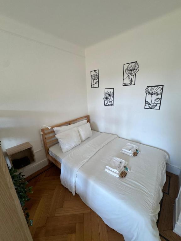 a bed in a room with pictures on the wall at Cosy studio a Lausanne center in Ouchy