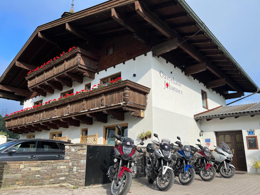 a group of motorcycles parked in front of a building at Gästehaus Johannes in Niedernsill