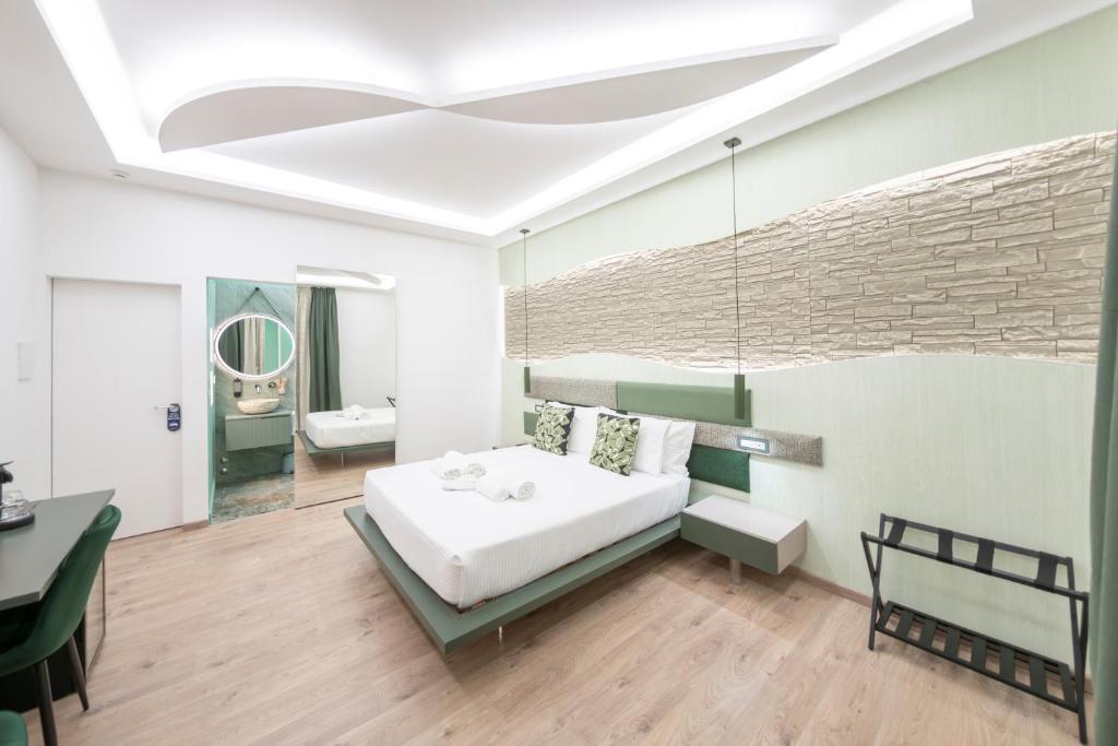 a bedroom with a bed and a brick wall at Giulio Cesare Luxury Rooms in Rome