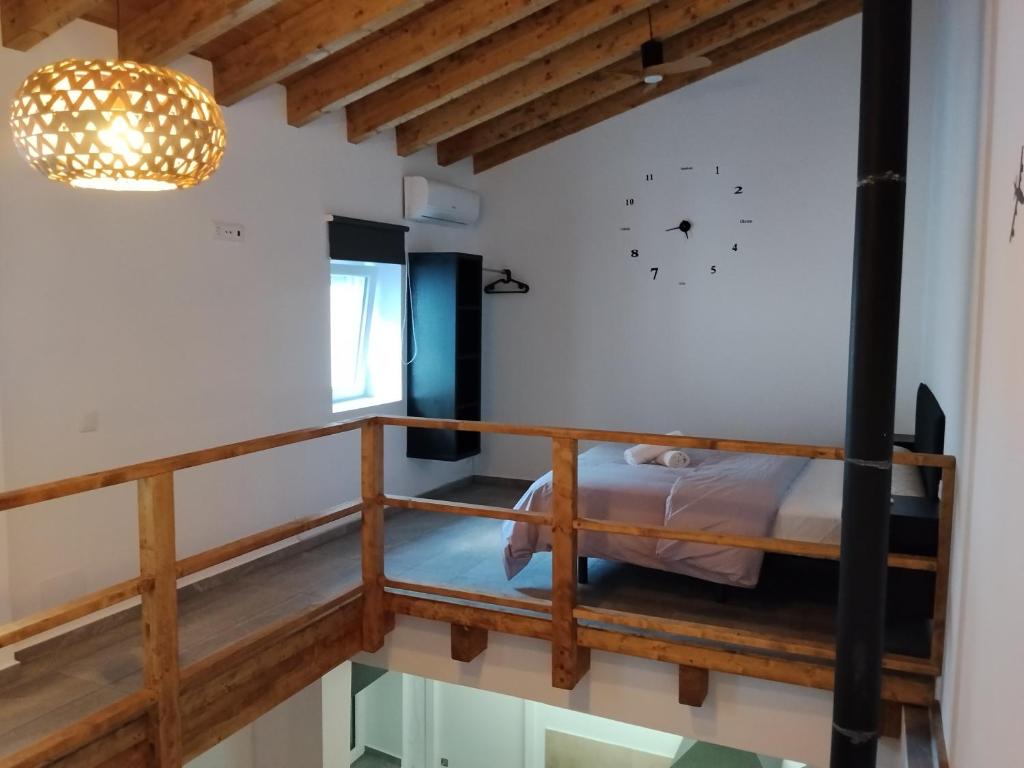a room with a bed and a clock on the wall at Apartamento Catalina in Algodonales