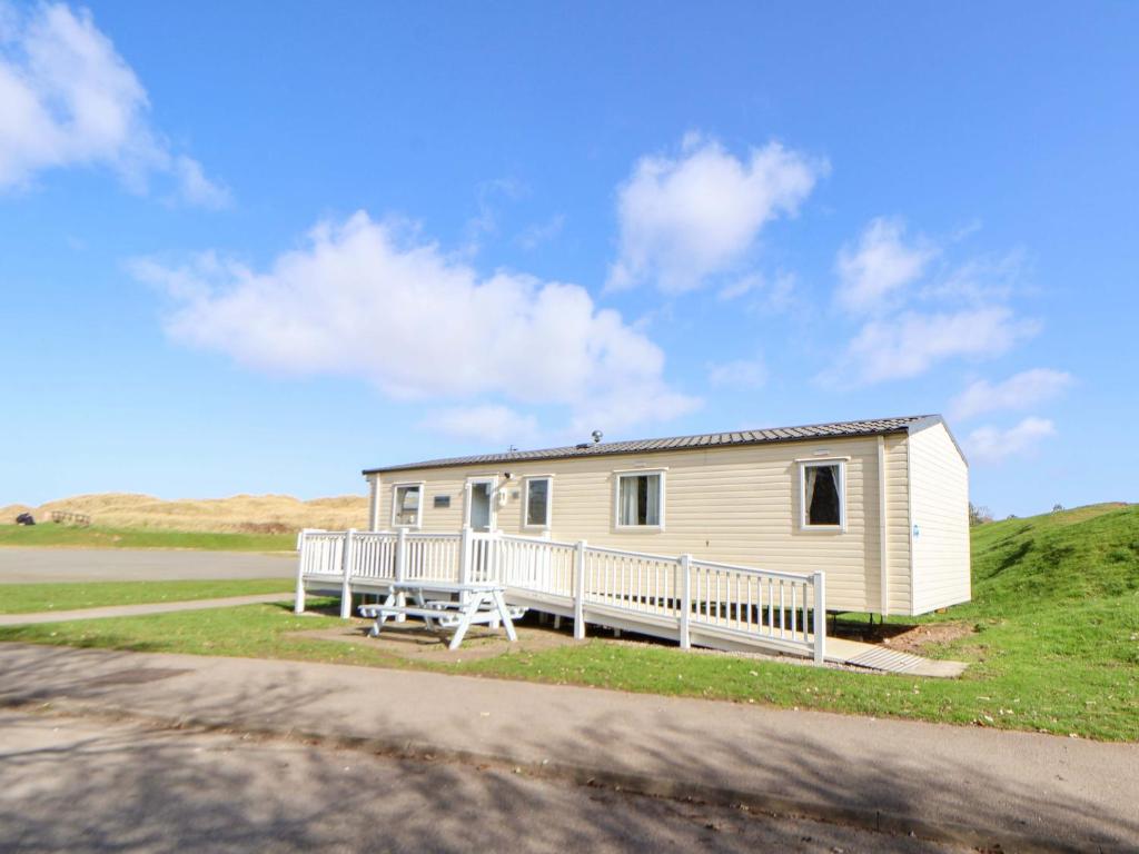 a mobile home on the side of a road at Dunes View in Prestatyn