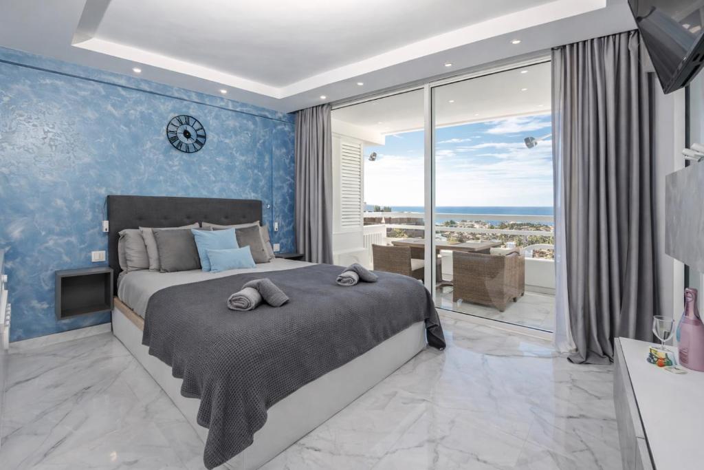 a bedroom with a large bed and a large window at Ocean View Ponderosa 601 Costa Adeje Playa de las Americas in Costa de Adeje