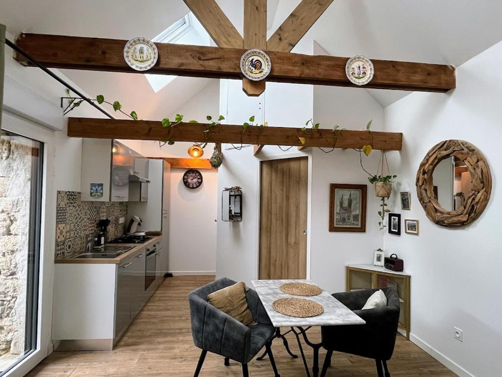 a kitchen and dining room with a table and chairs at La Grange de Marcel in Saint-Pol-de-Léon