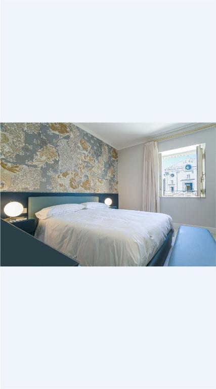 a bedroom with a large bed and a window at Piazza Duomo Guest House in Ariano Irpino
