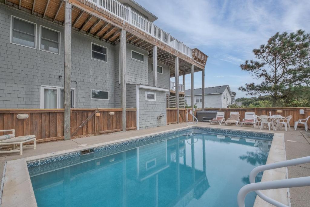 a swimming pool in front of a house at 3945 - Sea Lodge II in Duck