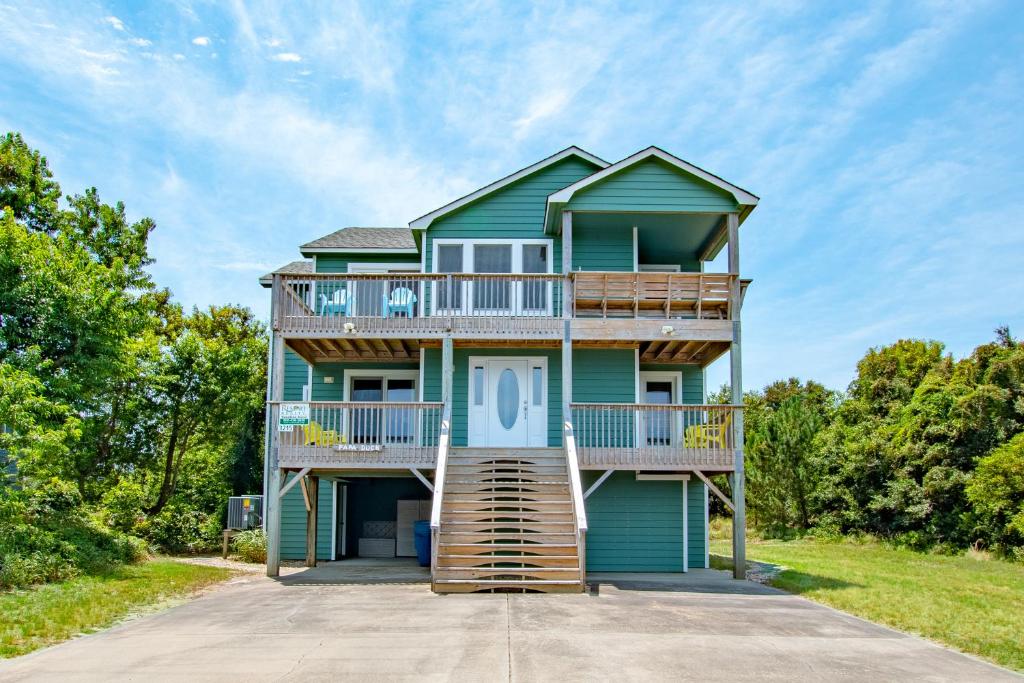 a house with a staircase up to the front of it at 3215 - Papa Duck in Duck