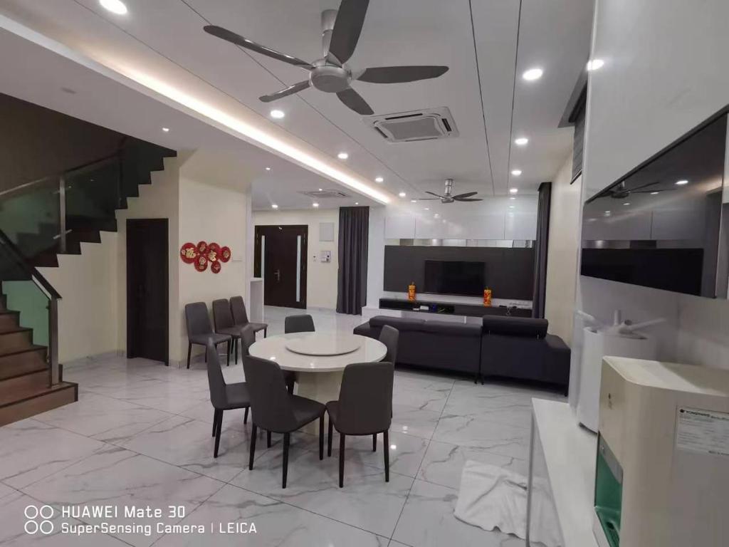 a living room with a table and chairs and a couch at Sweetsweet homestay in Banting