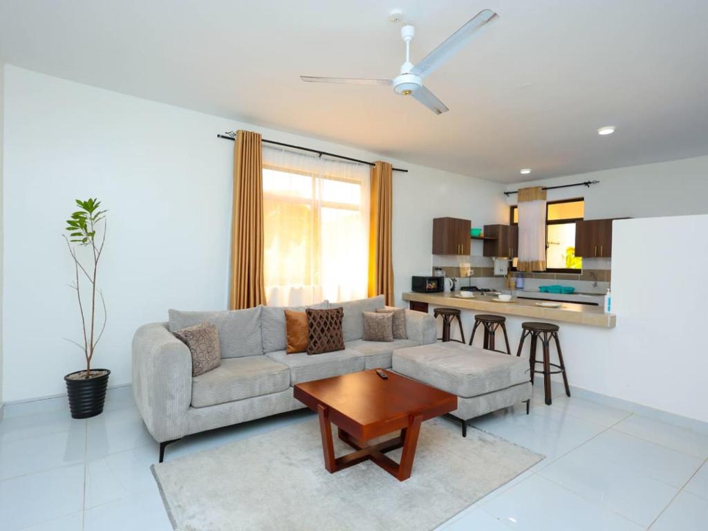 a living room with a couch and a table at Ntate Homes, Diani Near the Beach in Diani Beach