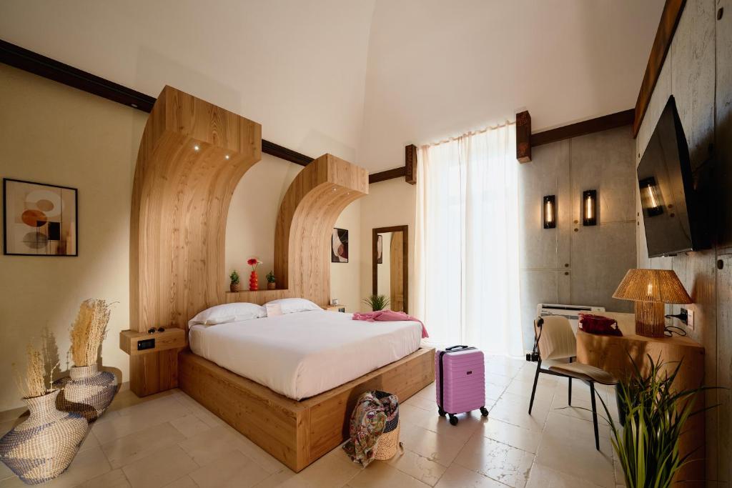 a bedroom with a large bed and a large window at Mamaco Trani in Trani