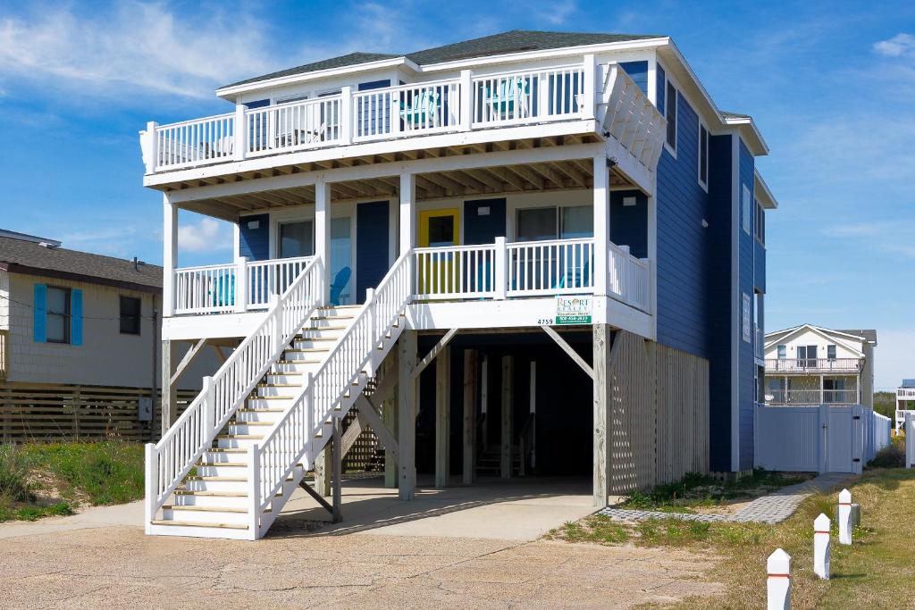 a large blue house with a balcony and stairs at 4759 - Sun Daze in Kitty Hawk Beach