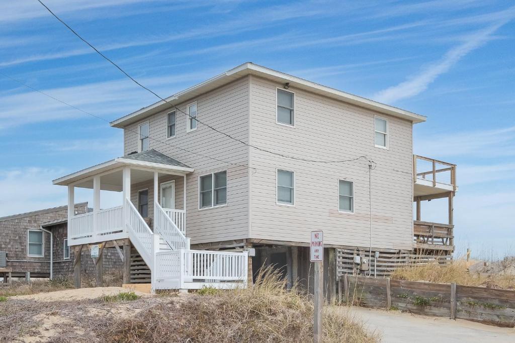 a large house with a white staircase in front of it at 5061 - Good Night Irene in Kill Devil Hills