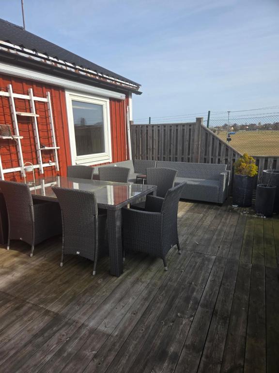 a patio with a table and chairs on a deck at Alvaret Solhyddan in Köpingsvik