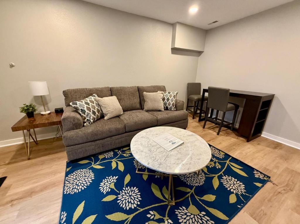 a living room with a couch and a table at Aksarben Modern 1Bed ground level with parking in Omaha