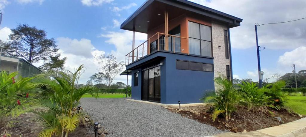 a house with a blue facade at Perla Arenal View in Fortuna