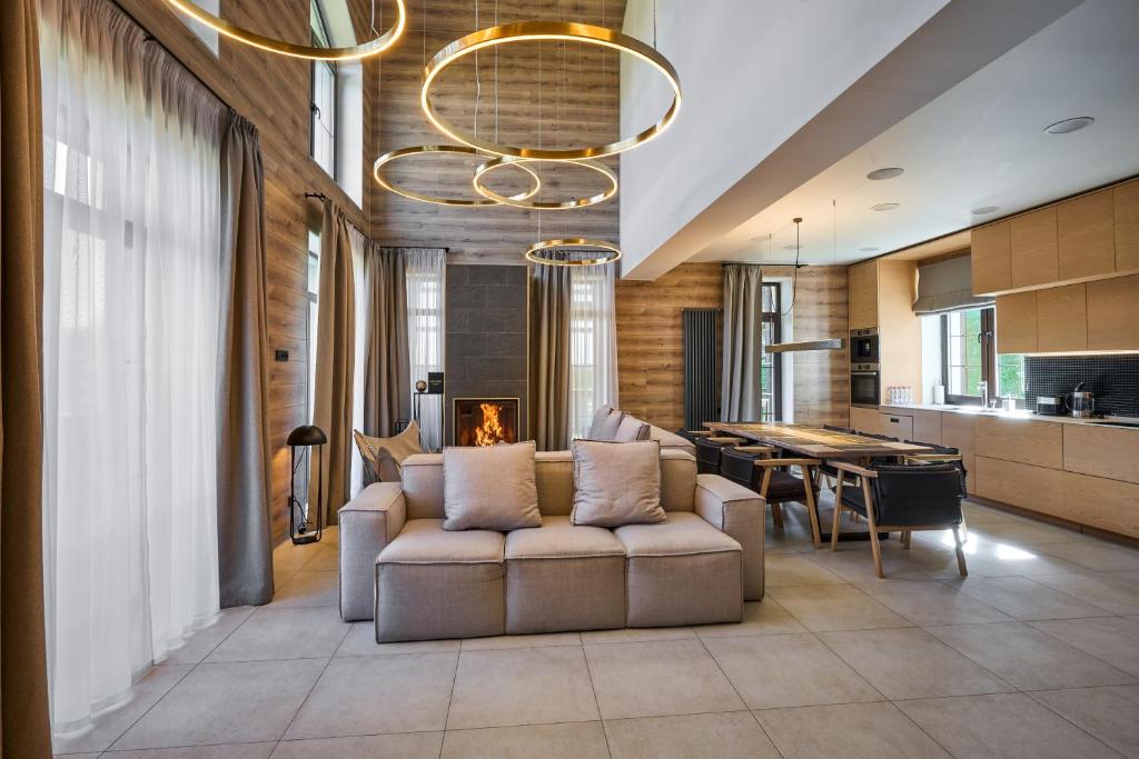 a living room with a couch and a dining room at Golden Chalet in Bukovel