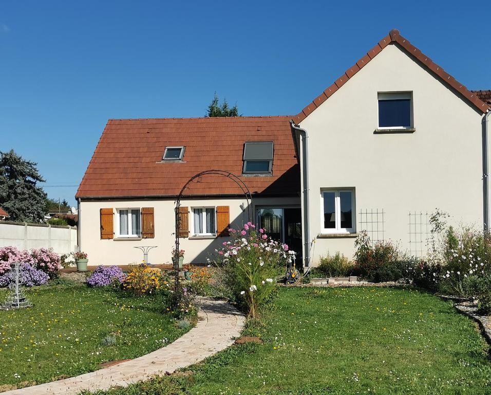 a white house with a garden in front of it at La Maison d'Eana in Maintenon