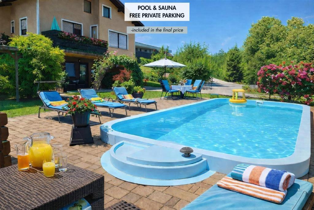 a pool and lounge area with chairs and a table at Apartma Xanadu in Slovenske Konjice