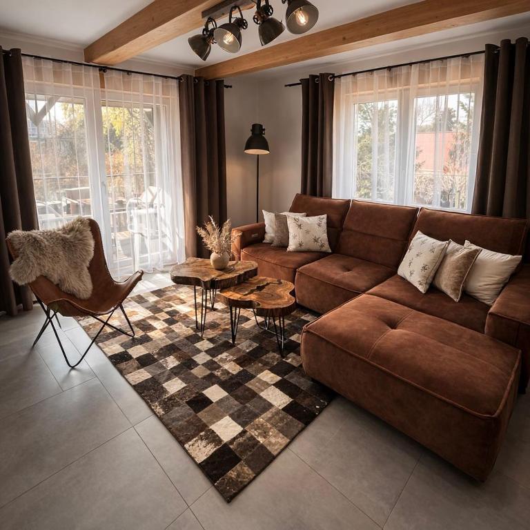 a living room with a couch and a table at Gajówka in Istebna