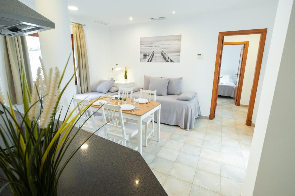 a living room with a table and a couch at Apartamentos Gravina in Tarifa