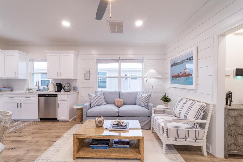 a living room with a couch and a table at Palmetto Place, Charming Saint Simons Bungalow in Saint Simons Island