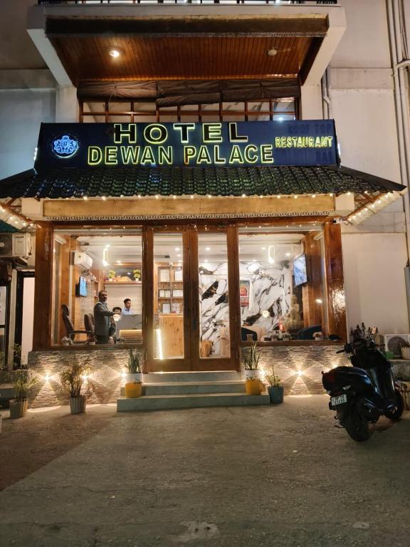 a hotelandan palace with a motorcycle parked in front of it at Hotel Dewan Palace in Dharmsāla