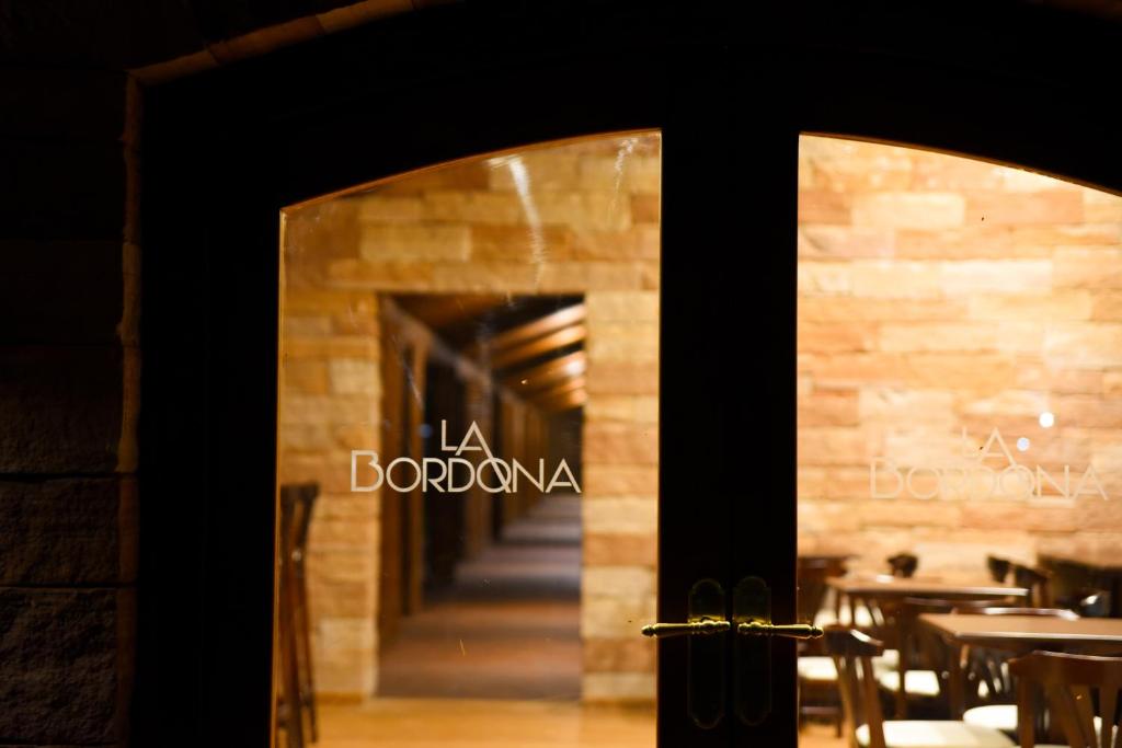 een deur naar een restaurant met een bord erop bij Hostería La Bordona in Rivera