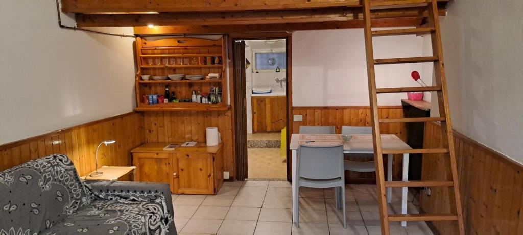 a living room with a bunk bed and a kitchen at Casa Pina in Como