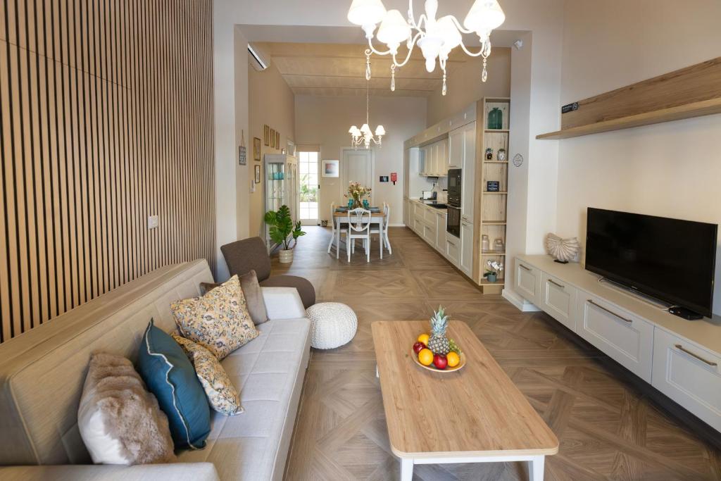a living room with a couch and a table at Pawlina Boutique Residence in St. Paul's Bay