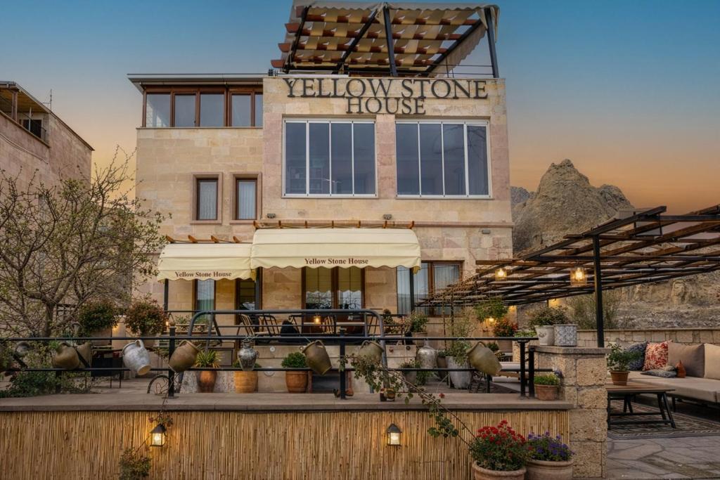 a building with a patio with a yellow stone house at Yellow Stone House in Göreme