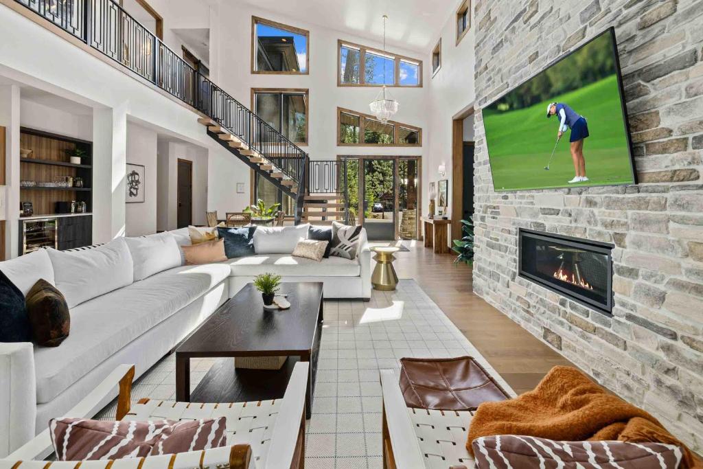 a living room with a couch and a tv on a brick wall at Onyx in Cle Elum