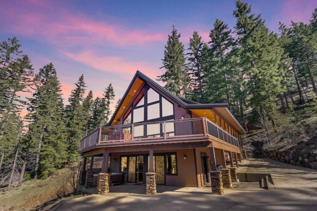 a house with a wrap around porch with trees at Crestview Lodge in Ronald