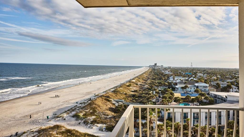 a view of the beach from the balcony of a condo at Dune House Hotel & Spa in Atlantic Beach