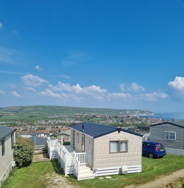 a house with a car parked in front of it at Swanage Caravan in Swanage