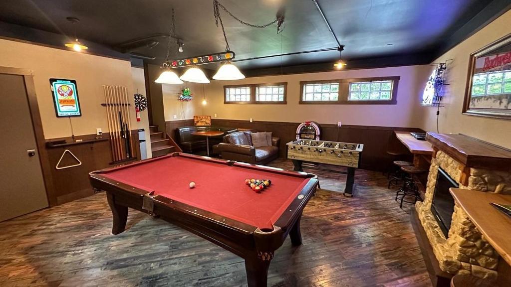 a living room with a red pool table in it at Gathering Place in Cle Elum