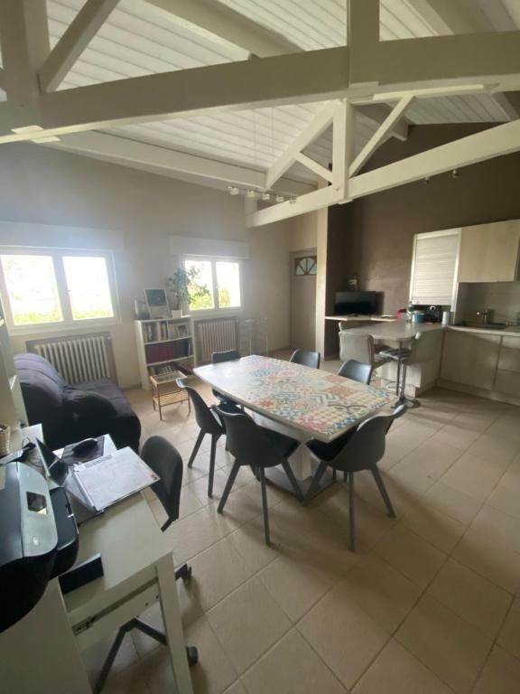a large living room with a table and chairs at Calme en vacances in Urrugne