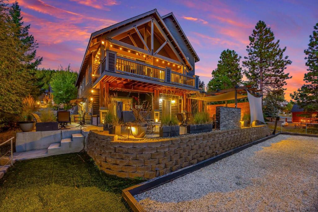 a large wooden house with a stone wall at Coal Chute Lodge in Ronald