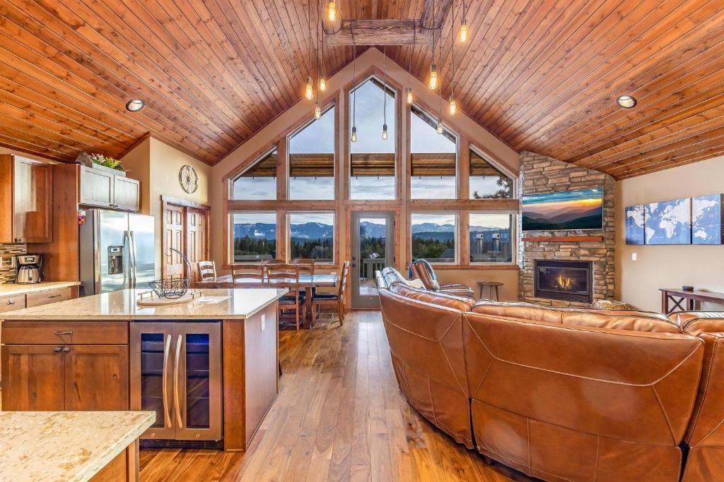 an open kitchen and living room with a large window at Huckleberry Hill in Ronald