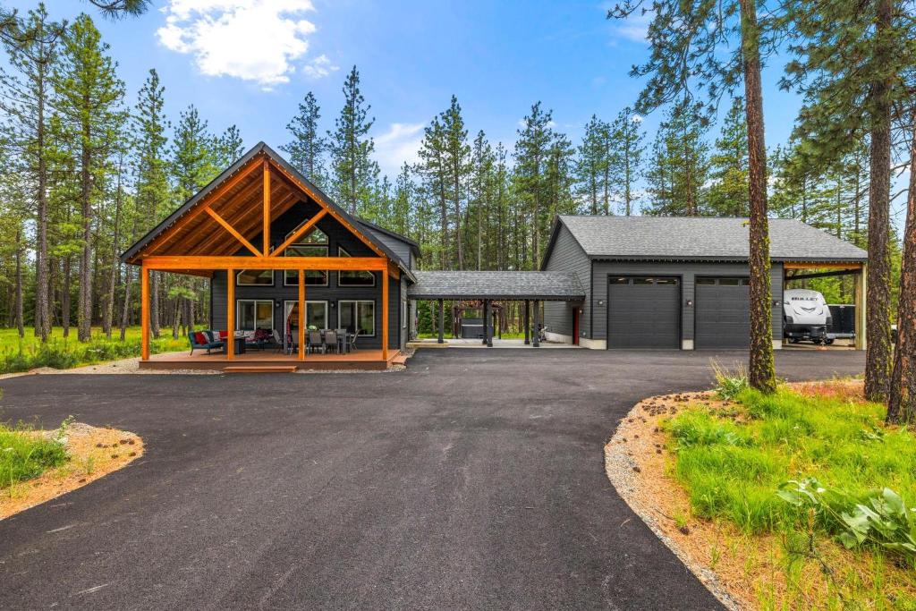 a house with a garage and a driveway at Crimson Cabin in Ronald