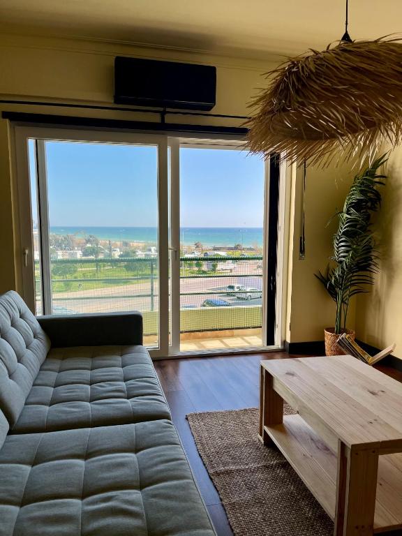 a living room with a couch and a table at Pérola VerdeMar in Quarteira
