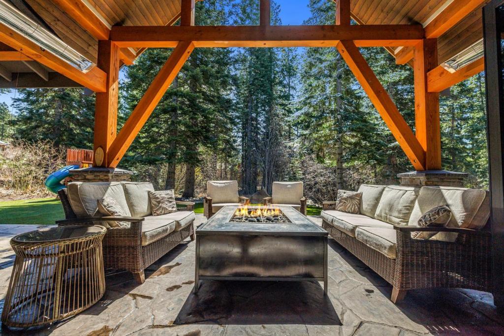 a patio with two couches and a fire pit at Cabin at the Crest in Ronald